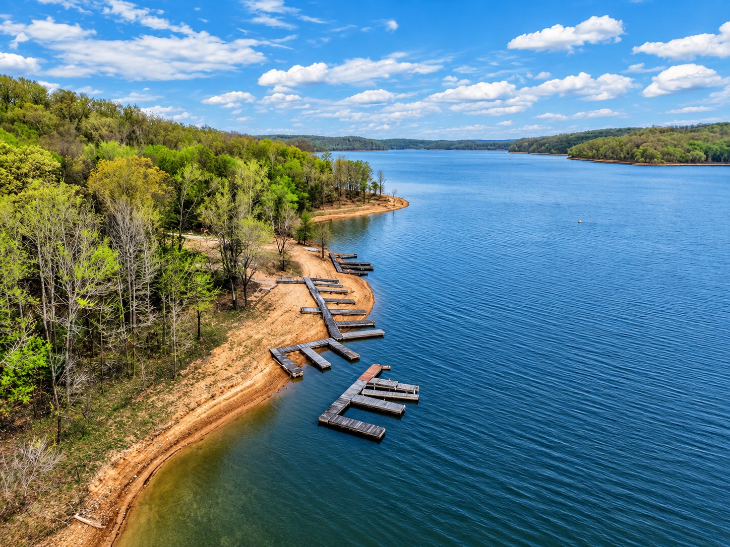 Wide angle drone aerial of lakefront land and waterway