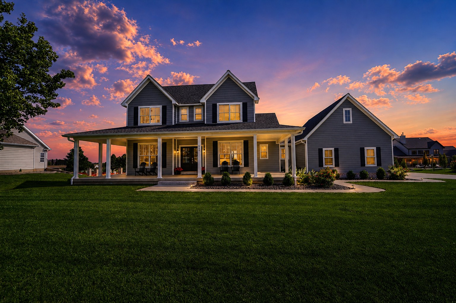 Gray country home with wraparound porch at dusk - HelixMind Real Estate Media